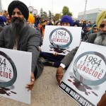 Sikh minority representatives sit in front the European headquarters of the United Nations in Geneva November 1, 2013. Earlier on Friday a delegation of representatives of several NGOs have submitted to the Office of the United Nations High Commissioner for Refugees (UNHCR) a petition urging to recognize the 1984 killing of Sikhs as 'Genocide'.  REUTERS/Denis Balibouse (SWITZERLAND - Tags: POLITICS CIVIL UNREST)