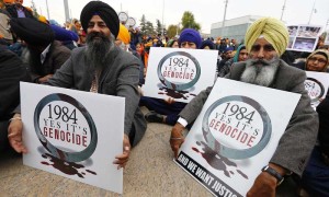 Sikh minority representatives sit in front the European headquarters of the United Nations in Geneva November 1, 2013. Earlier on Friday a delegation of representatives of several NGOs have submitted to the Office of the United Nations High Commissioner for Refugees (UNHCR) a petition urging to recognize the 1984 killing of Sikhs as 'Genocide'.  REUTERS/Denis Balibouse (SWITZERLAND - Tags: POLITICS CIVIL UNREST)