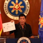 TRIAD CONNECTION. President Rodrigo R. Duterte shows a copy of a diagram showing the connection of high level drug syndicates operating in the country during a press conference at Malacañang on July 7, 2016. KING RODRIGUEZ/Presidential Photographers Division